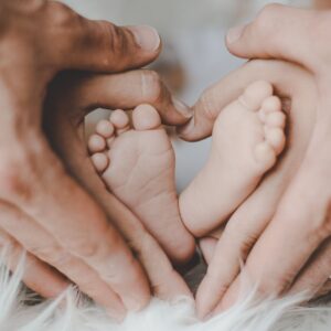 Baby Feet inside of a mom and dad's hands