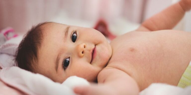 Baby in Bed Smiling -