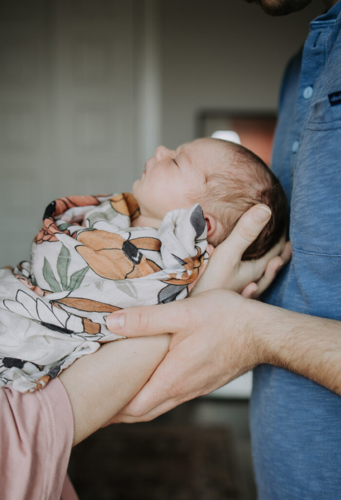 Couple holding their newborn baby