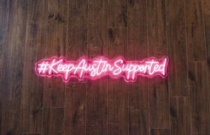 Neon light that says "#KeepAustinSupported